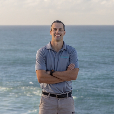 Jack, skilled leading hand, with the ocean behind him.