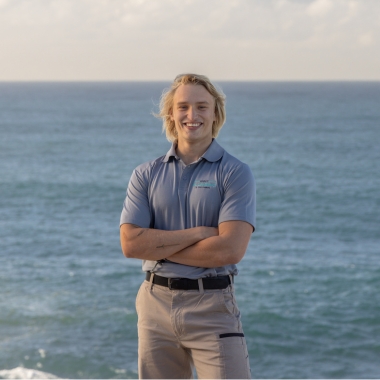 Lucas, expert pipe relining technician, with the ocean as the backdrop.