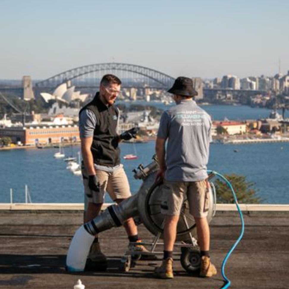 Plumbers completing a pipe relining job.