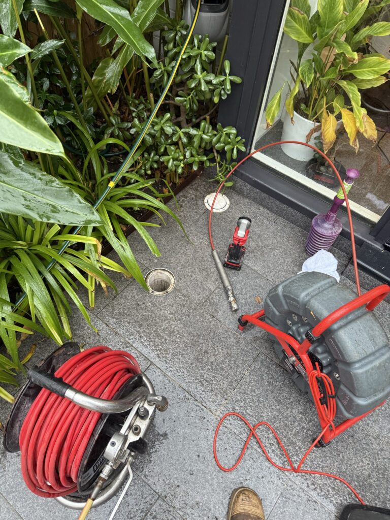 Sewer plumbing tools and inspection equipment prepared for diagnosing underground pipe issues.